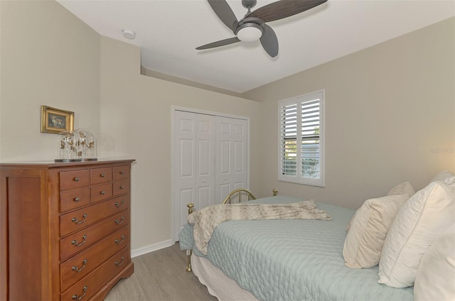 bedroom with light hardwood / wood-style floors, a closet, and ceiling fan