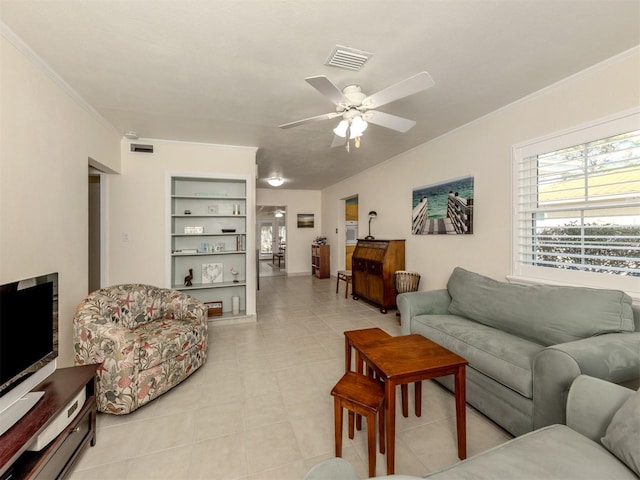 living room featuring ceiling fan, built in features, and crown molding