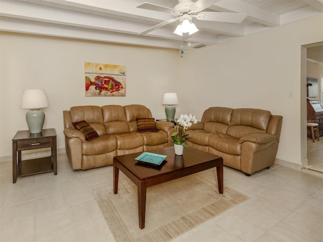 tiled living room with ceiling fan and beam ceiling