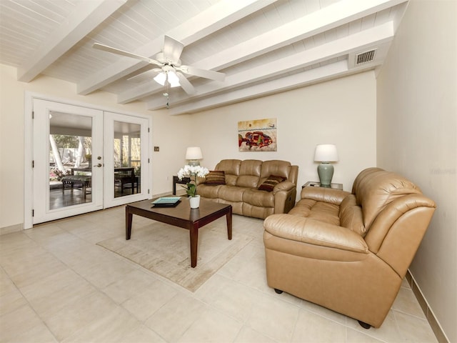 tiled living room with beam ceiling, ceiling fan, and french doors