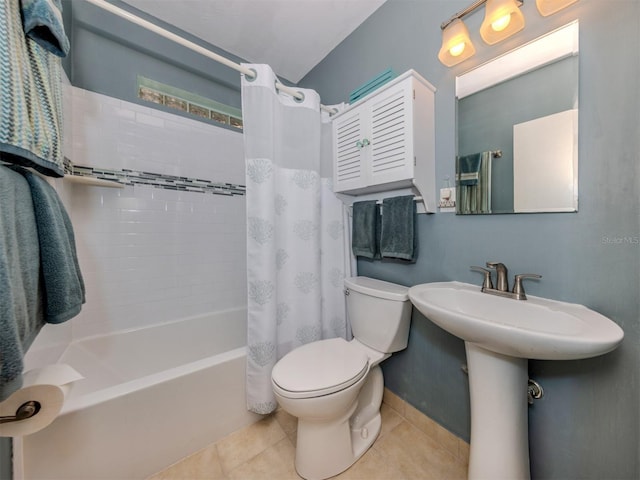 bathroom with tile patterned floors, shower / bath combo with shower curtain, and toilet