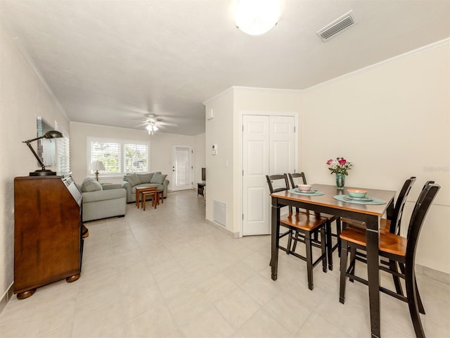 dining room with ceiling fan and crown molding