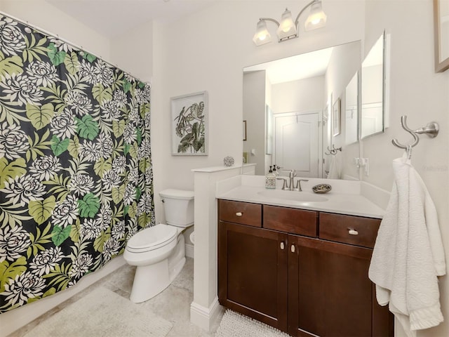 bathroom with tile patterned flooring, vanity, and toilet