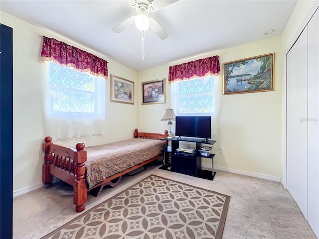 bedroom featuring ceiling fan, a closet, and carpet floors