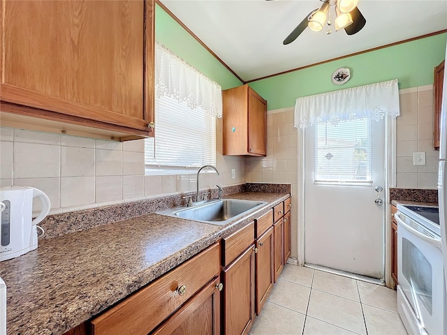 kitchen with backsplash, ceiling fan, sink, light tile patterned floors, and white range with electric cooktop