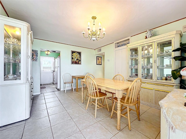 tiled dining room featuring an inviting chandelier