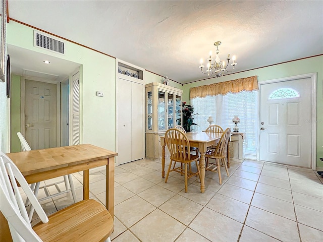 tiled dining space with a chandelier