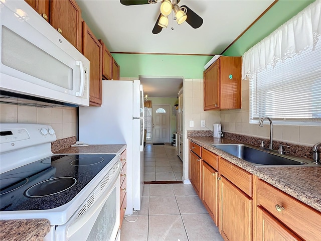 kitchen with white appliances, backsplash, sink, ceiling fan, and light tile patterned floors