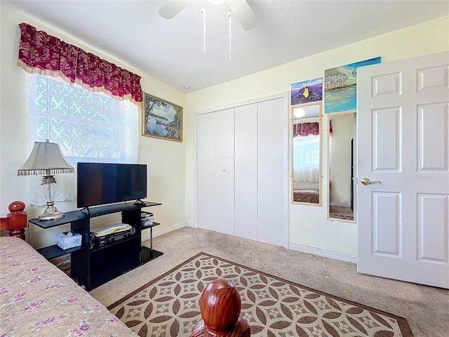 bedroom with carpet, ceiling fan, and a closet