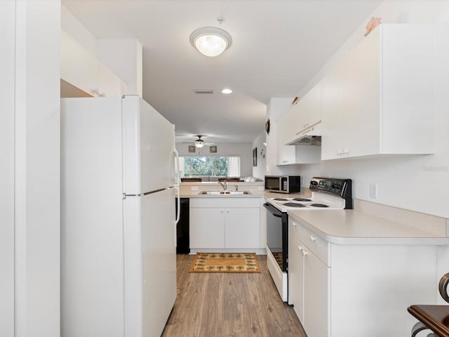 kitchen featuring white cabinetry, ceiling fan, sink, light hardwood / wood-style flooring, and white appliances