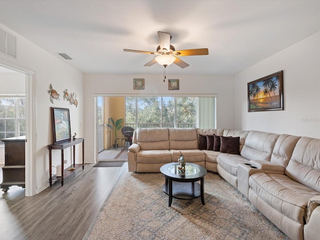 living room with ceiling fan and wood-type flooring