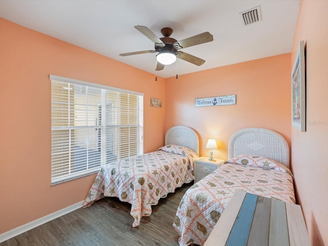 bedroom featuring ceiling fan and dark wood-type flooring