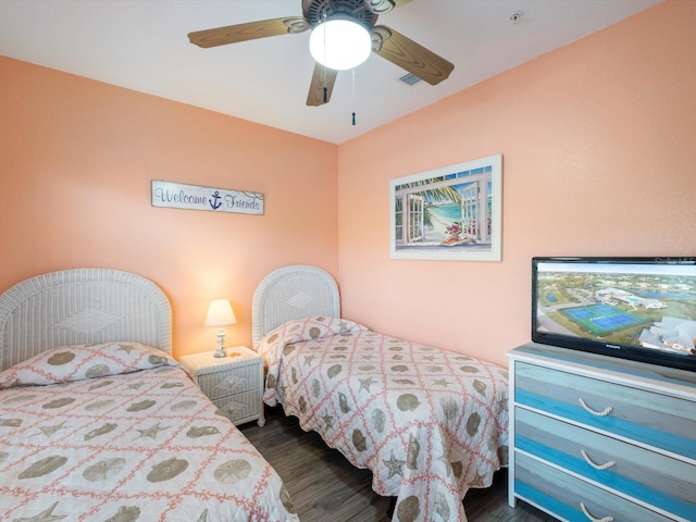 bedroom with ceiling fan and dark wood-type flooring