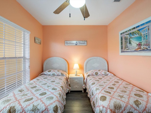 bedroom featuring ceiling fan and dark wood-type flooring