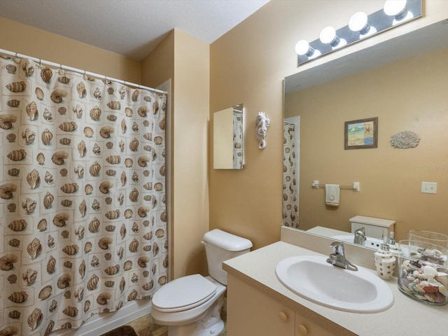 bathroom featuring vanity, a textured ceiling, and toilet