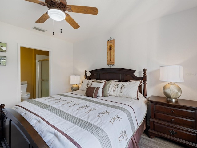 bedroom featuring ensuite bathroom, light hardwood / wood-style flooring, and ceiling fan