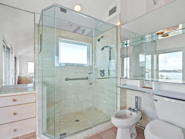 bathroom with walk in shower, tile patterned floors, a bidet, toilet, and vanity