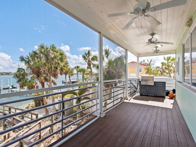 wooden terrace featuring ceiling fan, a water view, and grilling area