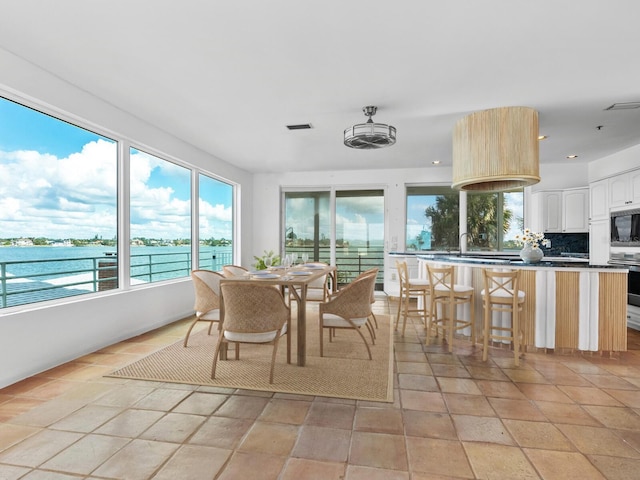 sunroom / solarium with a water view