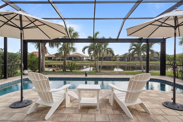 view of swimming pool featuring a water view, glass enclosure, and a patio area