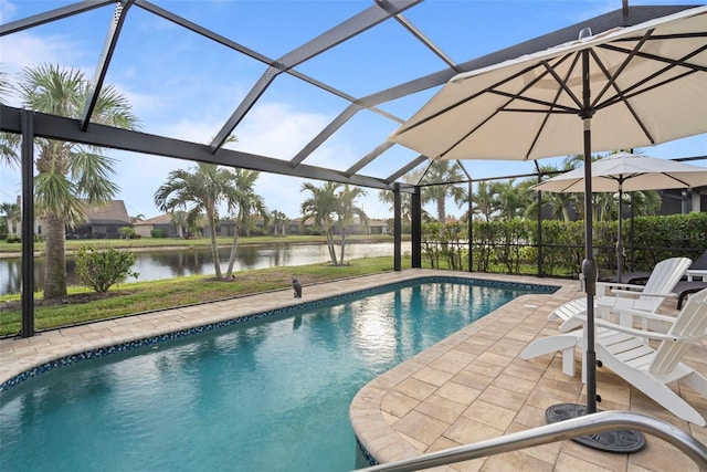 view of pool featuring a patio, a water view, and glass enclosure