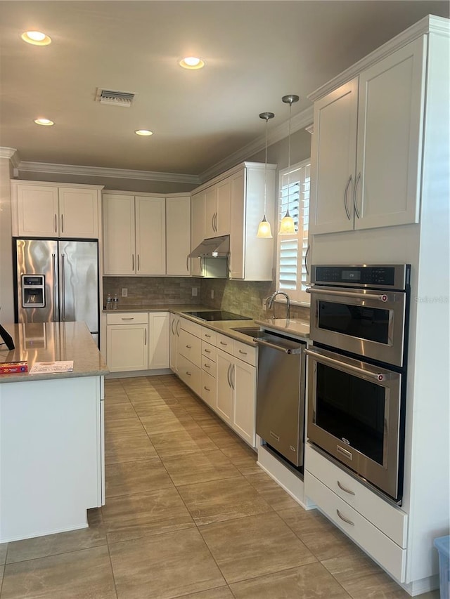13807 Karina St, Venice, FL 34293 - kitchen featuring stainless steel appliances, crown molding, under cabinet range hood, white cabinets, and backsplash
