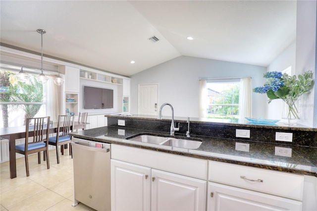 kitchen with lofted ceiling, dark stone counters, white cabinets, sink, and stainless steel dishwasher