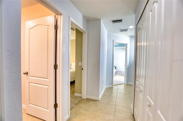 corridor with light tile patterned floors