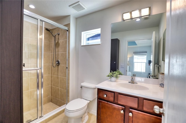 bathroom featuring vanity, toilet, and a shower with door