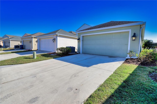 single story home featuring a front lawn and a garage