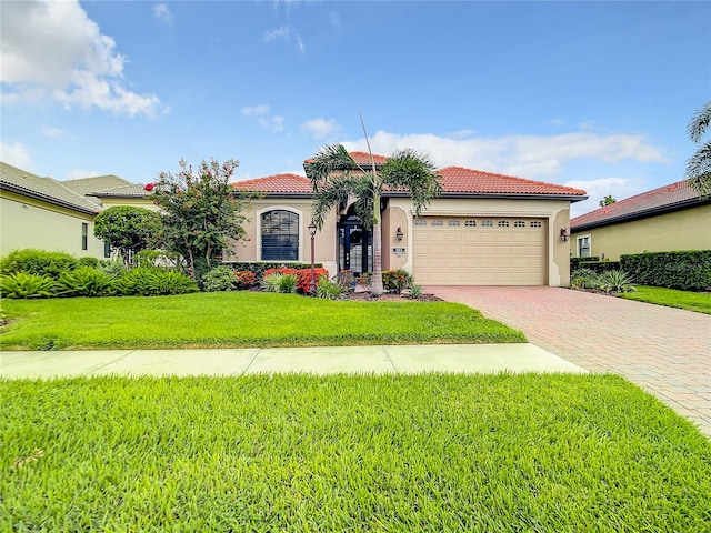 mediterranean / spanish house featuring a front lawn and a garage