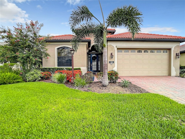 mediterranean / spanish-style house with a garage and a front lawn