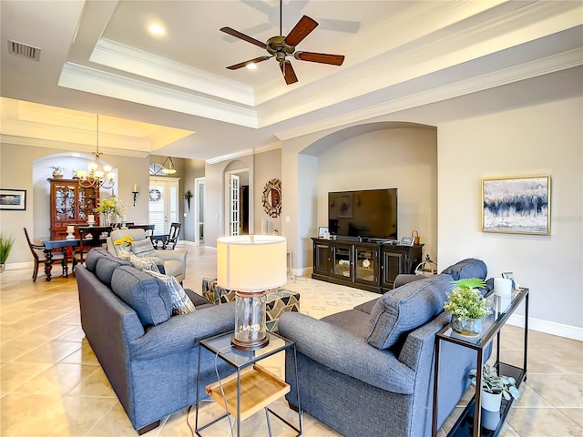 living room featuring a raised ceiling, light tile patterned floors, ceiling fan with notable chandelier, and ornamental molding