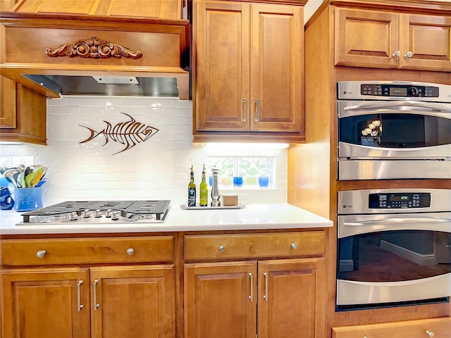 kitchen with stainless steel appliances and tasteful backsplash