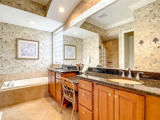 bathroom featuring tile patterned floors, vanity, crown molding, and tiled bath