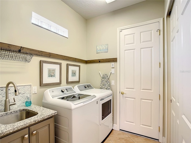 laundry room featuring cabinets, independent washer and dryer, light tile patterned floors, and sink