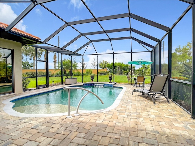 view of pool with glass enclosure, a patio area, and a lawn