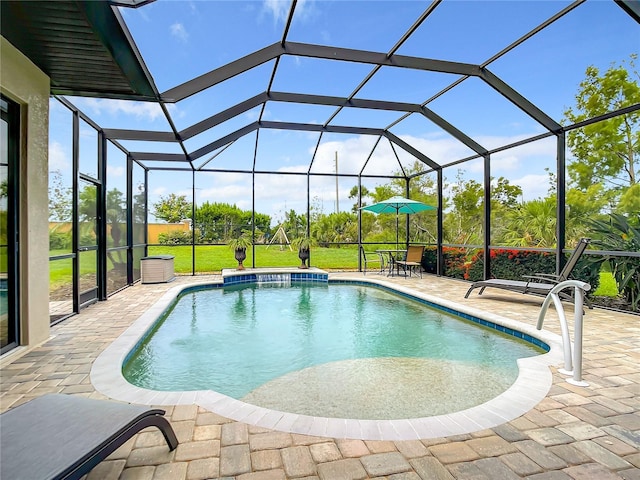 view of pool featuring a lanai, a yard, and a patio