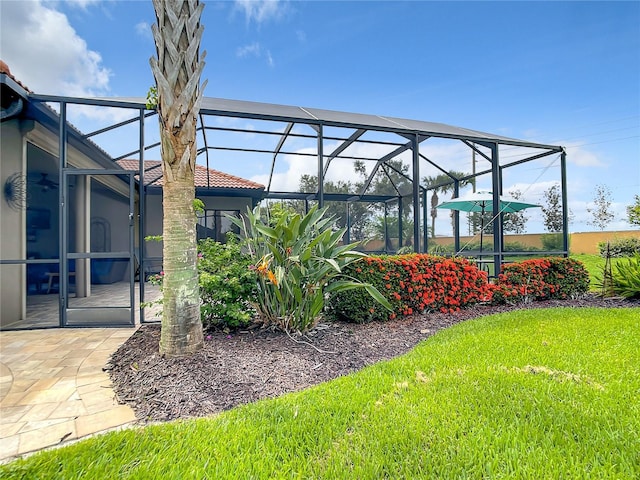 view of yard featuring glass enclosure