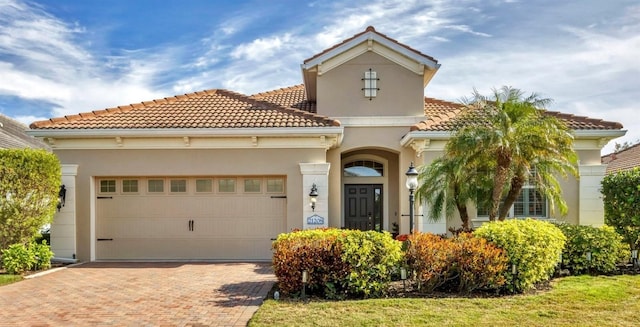 mediterranean / spanish-style house with a garage