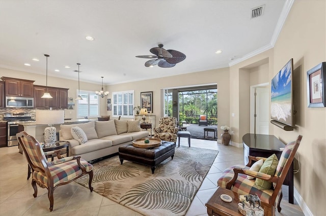 tiled living room with ceiling fan with notable chandelier and ornamental molding