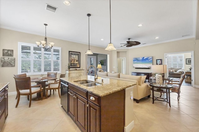 kitchen featuring pendant lighting, an island with sink, stainless steel dishwasher, and sink