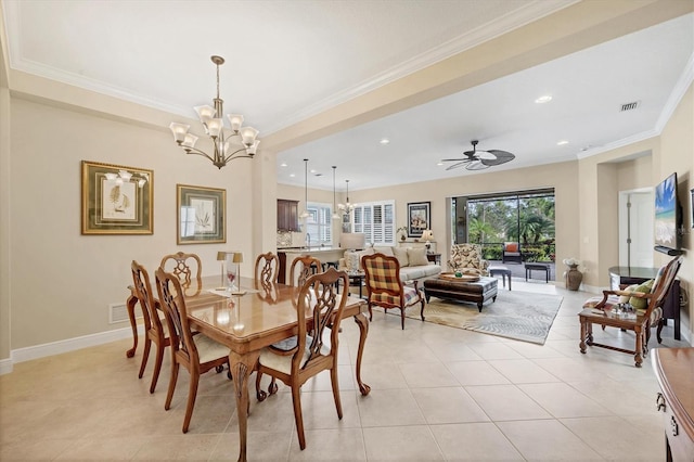 tiled dining room with ceiling fan with notable chandelier, plenty of natural light, and ornamental molding