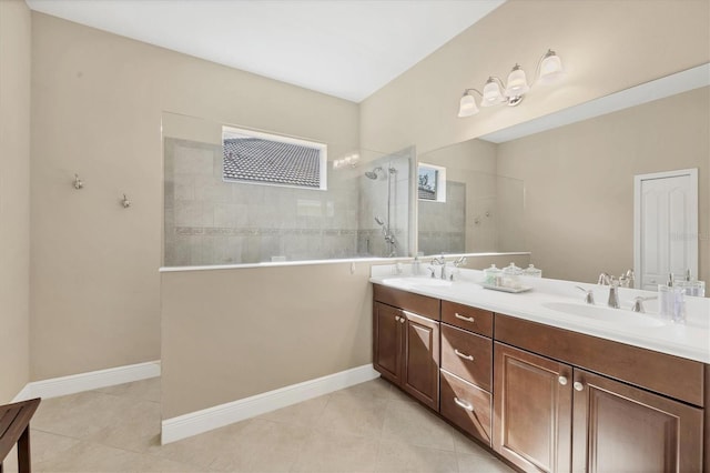 bathroom with tile patterned floors, vanity, and tiled shower