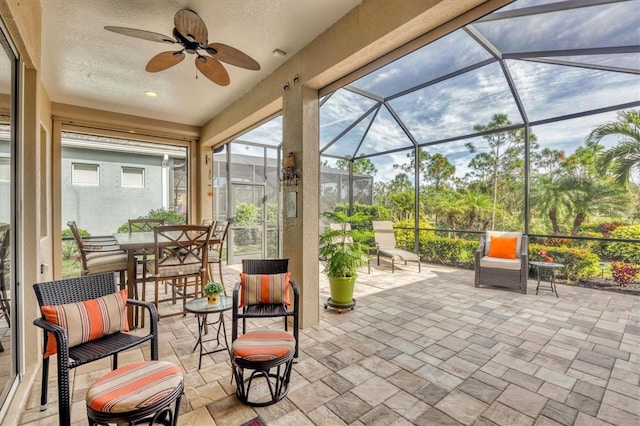 view of patio with ceiling fan and a lanai