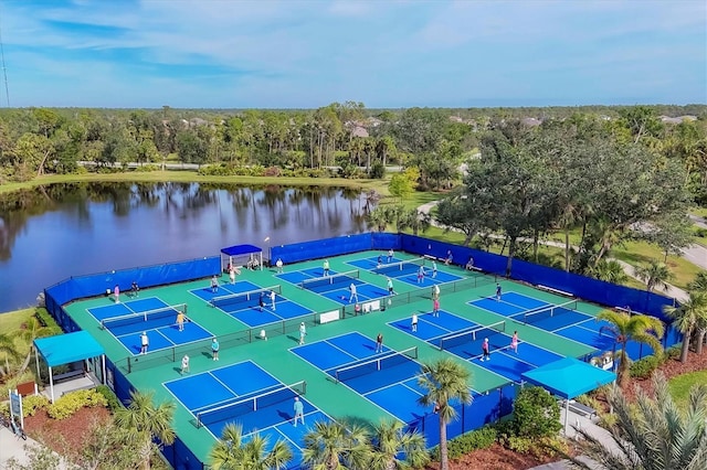 view of tennis court with a water view