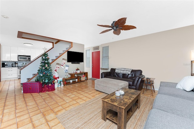 living room with light tile patterned floors and ceiling fan