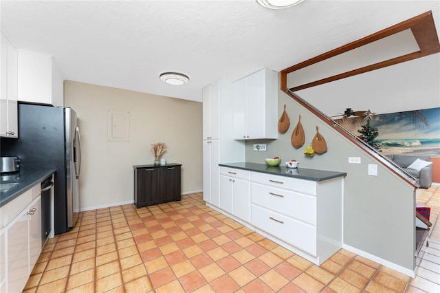 kitchen featuring white cabinetry, light tile patterned floors, a textured ceiling, and ceiling fan