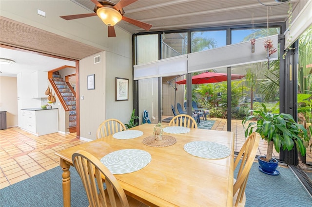 dining space with ceiling fan and light tile patterned flooring