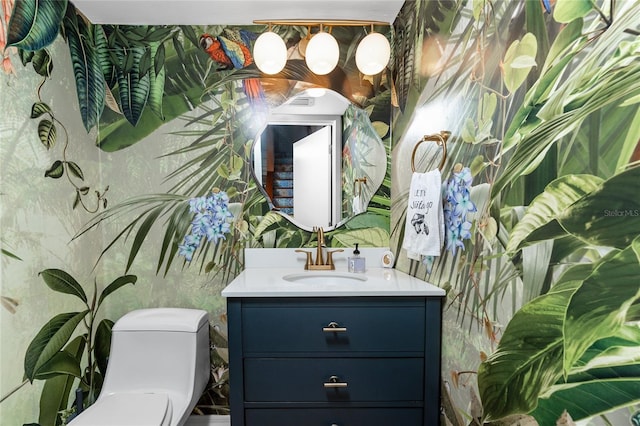 bathroom featuring vanity and toilet